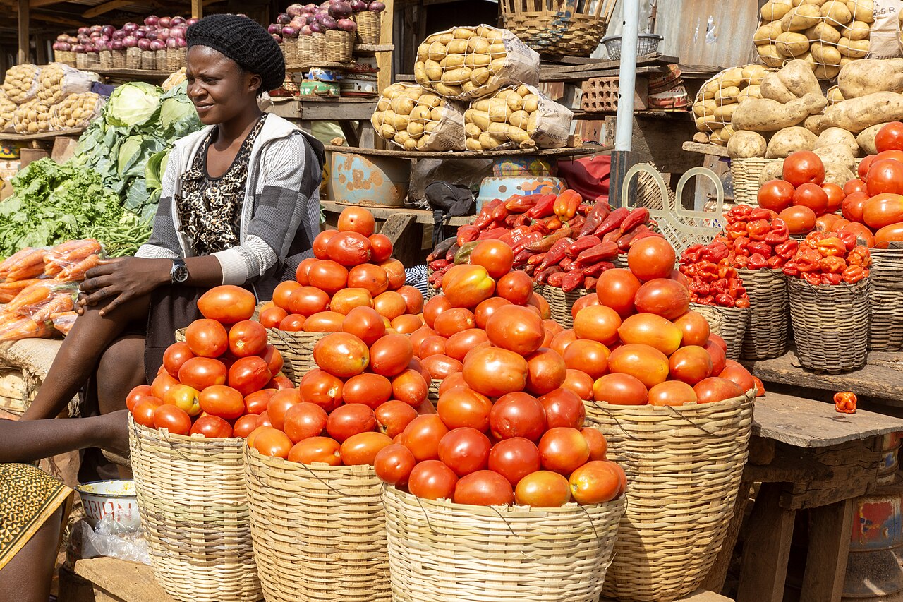 Baskets of tomatoes and vegetables at a produce market
