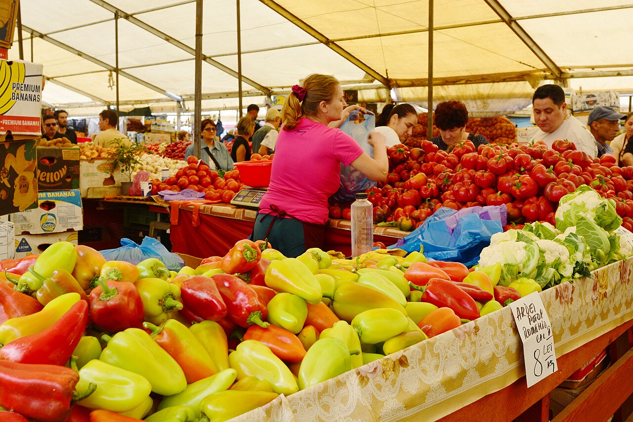 Open-air booth selling tomatoes and peppers